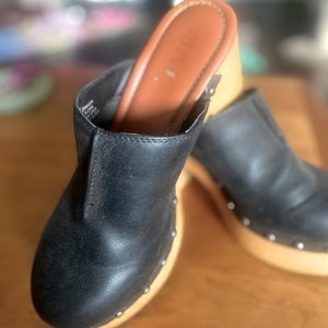 A midsole ,studs a retro-chic clog lifted by a faux wood platform and block heel